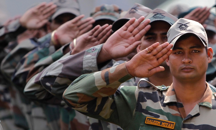 Indian army soldier Saleem Miyan (R)  and his colleagues salute in Srinagar